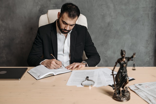 lawyer working with a lady justice statue on the desk